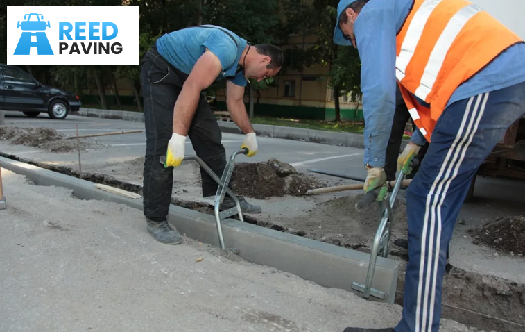 Concrete paving installation in progress, showcasing workers laying slabs