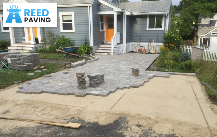 Paving installation halfway through, highlighting the process and materials used.